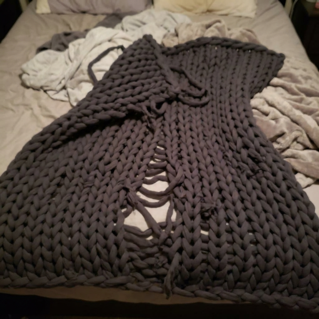 Knitted blanket showing wear and damage